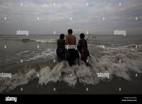 People From The Hindu Community Bathe At The Bay Of Bengal During The