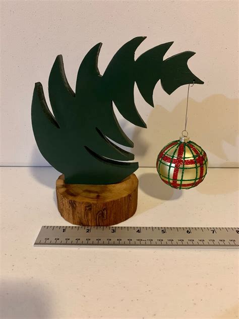 Small Leaning Grinch Style Christmas Tree With Natural Tree Trunk Base