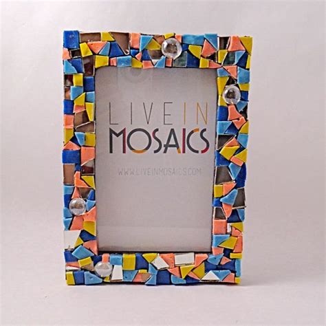 A Multicolored Photo Frame With The Words Live In Mosaics On It