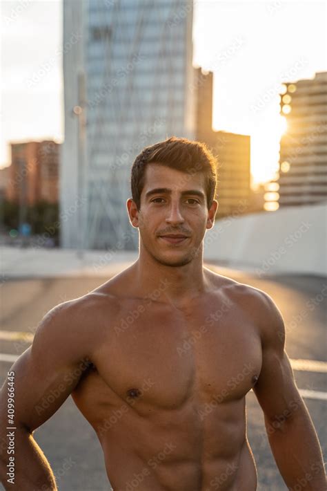 Crop Masculine Athlete With Naked Torso And Muscles Looking At Camera On Asphalt Roadway After