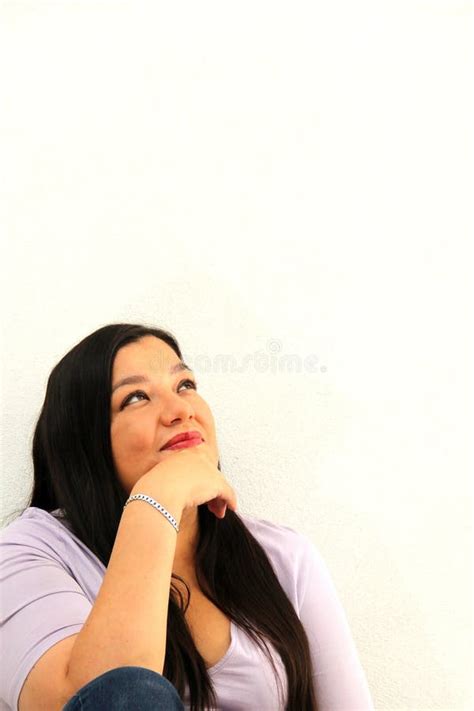 40 Year Old Latina Woman Cares And Brushes Hair In The Bathroom In A Bathrobe In Front Of The