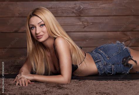 Sexy Blonde Woman Wearing Jeans Shorts And Lying Stock Photo Adobe Stock