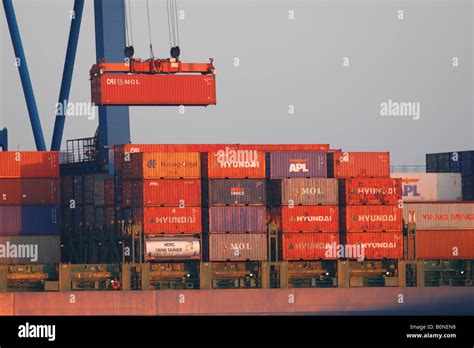 Crane Lifting Shipping Containers Onto Container Ship Stock Photo Alamy