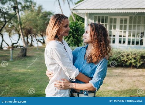 Happy Lesbian Couple Hugging In The Garden At Their Country House Stock Photo Image Of Home