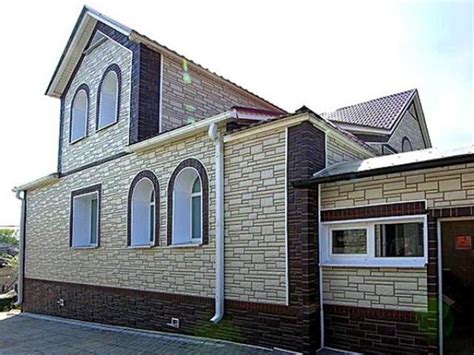 Отделка фасада дома панелями под камень - фото