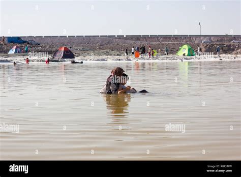 A Mother With Her Son Swimming In The Urmia Lake West Azerbaijan