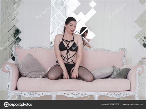 Happy Plus Size Mix Race Woman Posing In Fashion Lingerie And Stockings Indoors In White