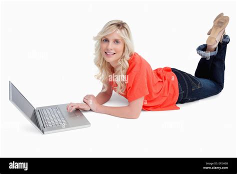 Smiling Blonde Woman Crossing Her Legs In Front Of Her Laptop Stock Photo Alamy