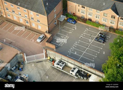 An English health centre with an almost empty car park. Only a few cars ...