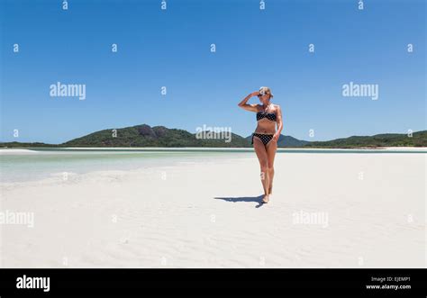 A Mature Woman Walking On The White Sands Of Whitehaven Beach In Australia Stock Photo Alamy