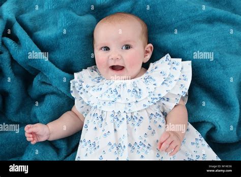 15 Week Old Baby Girl Laying Down In Nursery On Soft Play Area Stock