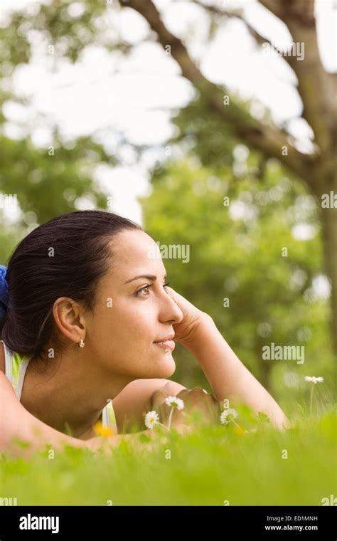 Fit Brunette Lying And Thinking On Grass Stock Photo Alamy