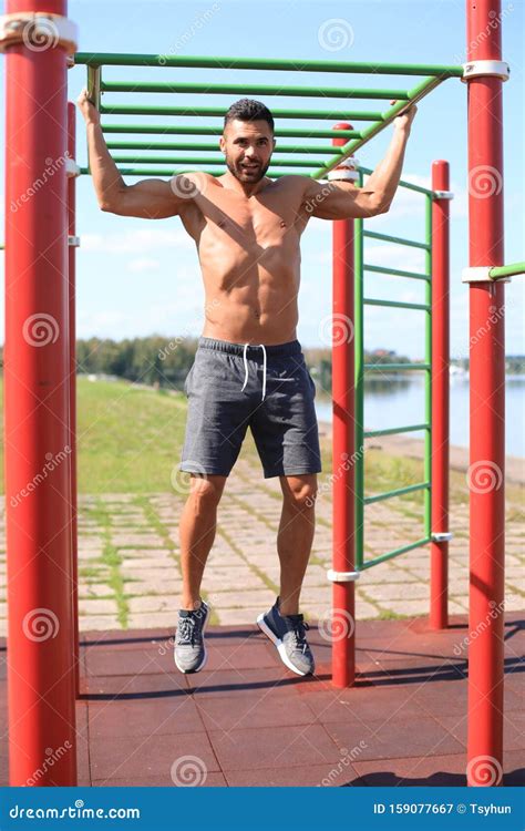 Muscular Guy With Naked Torso Pulling Up On Horizontal Bar Outdoor Stock Image Image Of Pull
