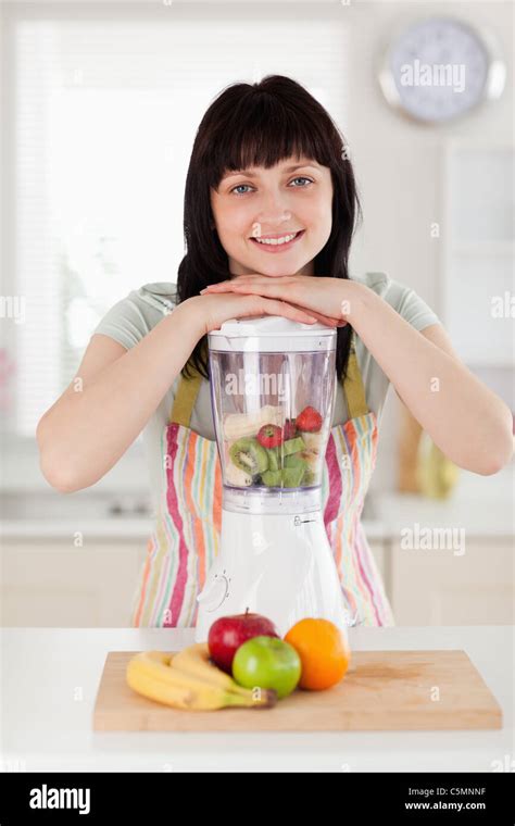 Pretty Brunette Woman Posing With A Mixer While Standing Stock Photo Alamy