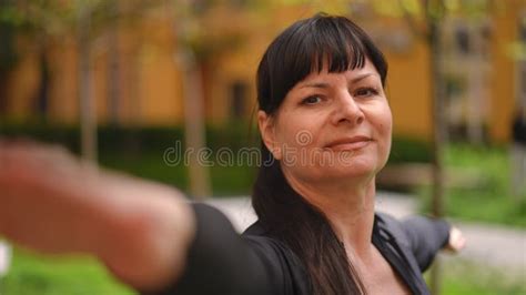 Close Up Mature Woman S Face During Yoga Pose Woman Spreads Arms Out To The Sides And Looks At