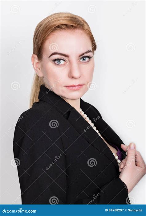 Attractive And Energetic Business Woma In A Suit On Naked Body Smiling Holding Pearls Stock