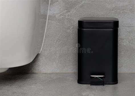 compact black pedal trash bin  minimalist bathroom stock photo