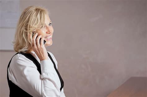 Premium Photo Blonde Receptionist Talks With Customer Booking King Room