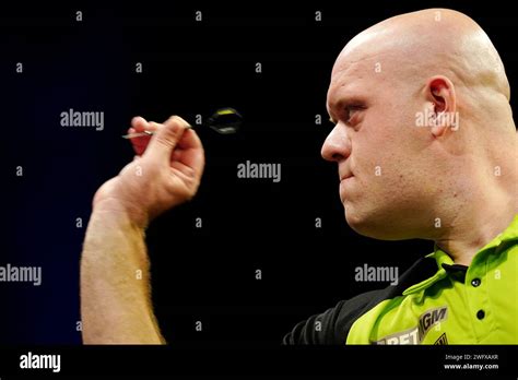 Michael van Gerwen in action against Michael Smith (not pictured ...