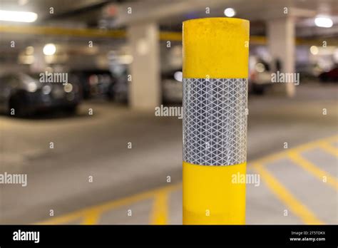 Yellow Parking Garage Pole Close Up Cars In Background Stock Photo