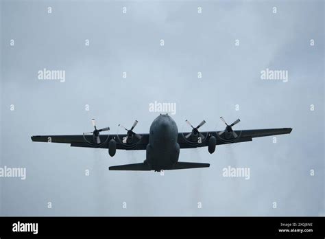 Four-engine turboprop military transport aircraft in the sky. (Lockheed ...