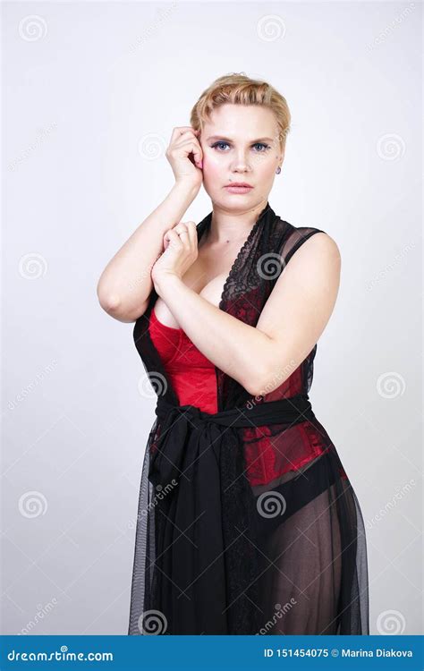 Beautiful Chic Plus Size Blonde With Short Hair In Red Lace Corset And Black Sheer Long Robe In