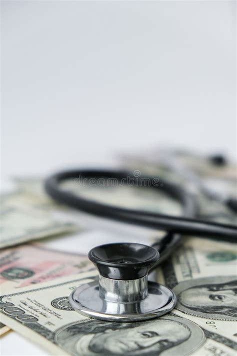 Stack Of Cash Dollars And Stethoscope The Concept Of Medical Expensive