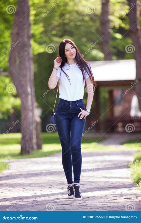 Portrait Of Beautiful Happy Stylish Woman In Blue Jeans Stock Photo