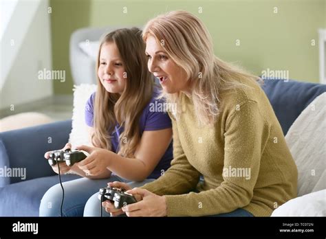 Mature Woman And Her Cute Granddaughter Playing Video Game At Home Stock Photo Alamy