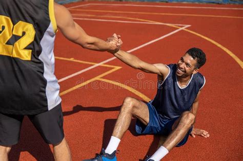 Basketball Players On Basketball Court After Playing Intense Match