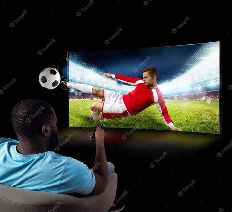 Premium Photo | Viewer in front of a tv on the armchair at home feels