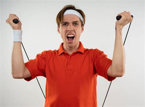 Free Photo Excited Young Sporty Guy Wearing Headband With Wristband