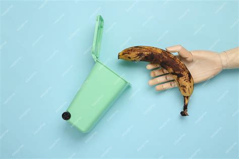 Premium Photo Recycling Concept Wooden Hand Throws Rotten Banana Into