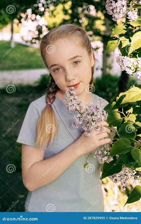 Portrait Of A Beautiful Girl Of 14 Years Old With Long Blonde Hair The Girl With Braids Looks