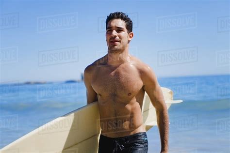 Man Carrying Surfboard On Beach Stock Photo Dissolve