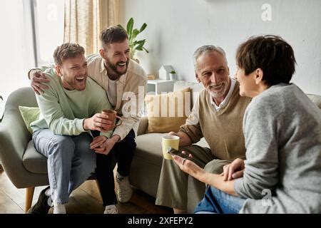 A Gay Couple Smiles And Laughs While Meeting Parents At Home Stock Photo Alamy