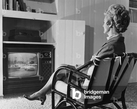 Image Of Side Profile Of A Mature Woman Watching Television