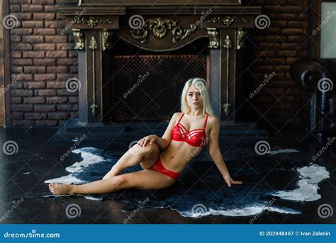 Fashion Model With Blond Hair Posing In Bedroom Wearing Red Lingerie Stock Image Image Of