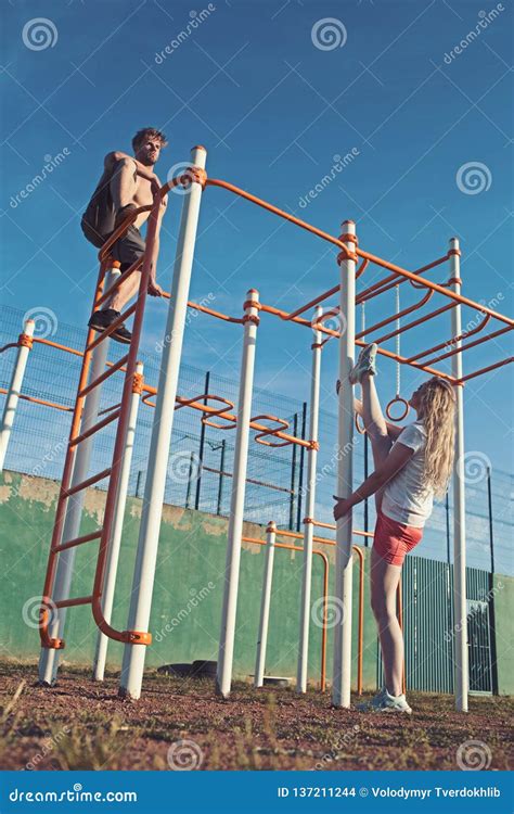 Man Athlete Climb On Metal Jungle Gym On Blue Sky Sportsman With Bare