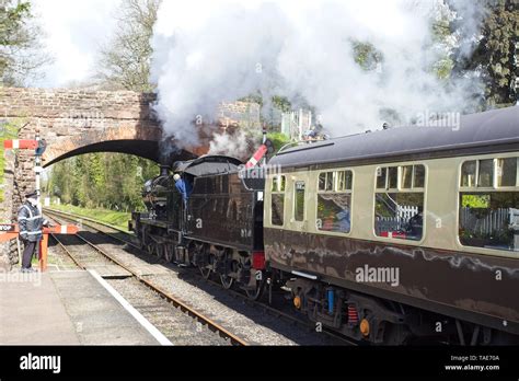 Steam train just leaving the station on a heritage railway line ...