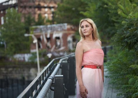 Blonde Model Poses In Park Wearing Pink Strapless Dress Stock Image Image Of Blond Beautiful