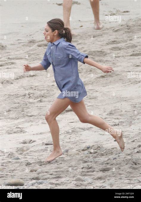 Mila Kunis Runs In Her Bikini And A Short Blue Shirt While Filming A Scene For Friends With