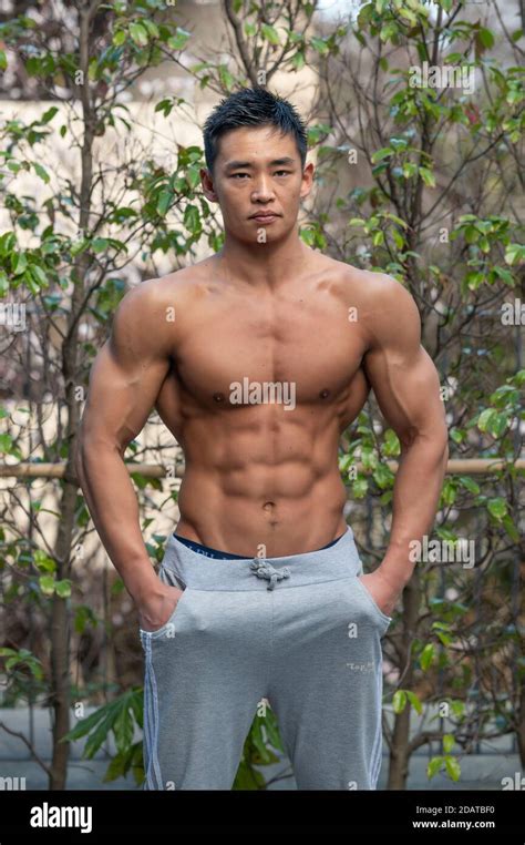 A Muscular Male Japanese Amateur Bodybuilder Poses Outdoors In A Street In Tokyo Stock Photo Alamy