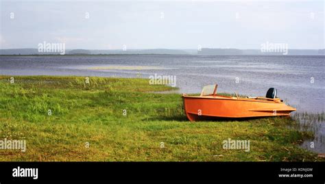 Orange boat at the lakeshore. Russian North. Tonde photo. Wide format ...