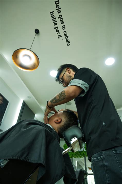 Barber Giving a Stylish Haircut in Cuenca Shop · Free Stock Photo