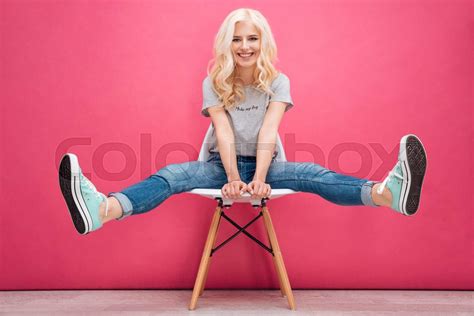 Funny Blonde Woman Sitting On The Chair Stock Image Colourbox