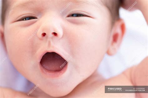 From Above Adorable Naked In Infant Yawning Sweetly While Lying On Soft Bed At Home Harmony