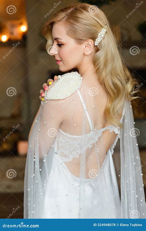 Portrait From The Back Of A Beautiful Blonde And Bride With An Attractive Body Dressed In