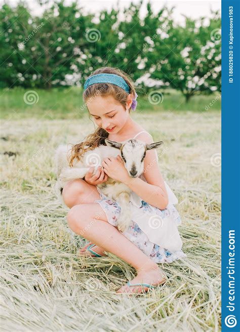 Girl With Baby Goat On Farm Outdoors Love And Care Village Animals