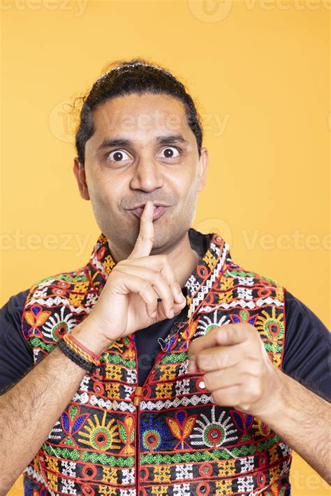 Authoritative man doing shushing hand gesturing, demanding secrecy